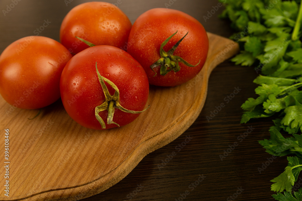 Red tomatoes on a wooden board and a dark textured wood background. With herbs.
Eco-friendly tomatoes. Fresh tomatoes. Tomatoes with water drops Red tomatoes on a wooden board and a dark textured wood background. With herbs.
Eco-friendly tomatoes. Fresh tomatoes. Tomatoes with water drops