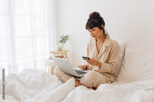 Woman making online payment using credit card