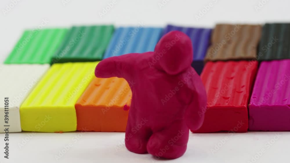 Stop motion of sculpting pieces of modeling clay creating a man. Timelapse plasticine handmade background
