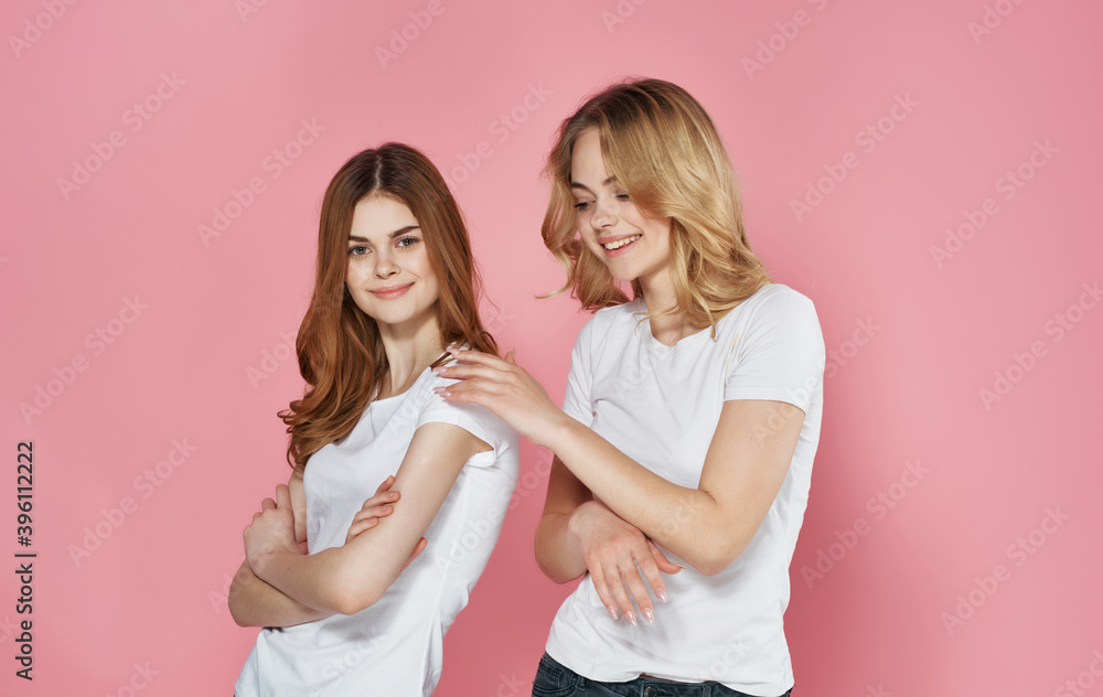 two funny girlfriends in white t-shirts spring hug communication two funny girlfriends in white t-shirts spring hug communication