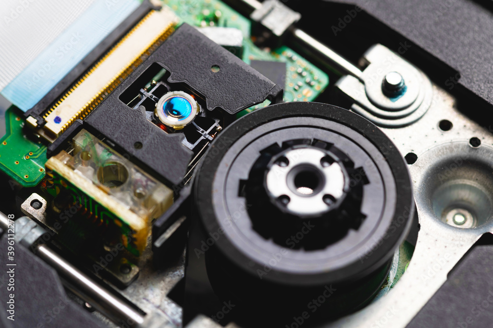 Close-up of a laser lens for reading and writing dvd roma cd drive. Readout optical design Close-up of a laser lens for reading and writing dvd roma cd drive. Readout optical design