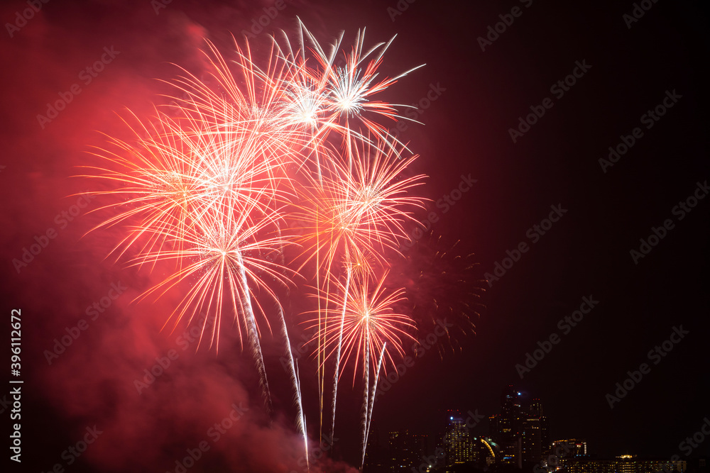 Firework festival with beach foreground and city background at Pattaya beach, Thailand. Colorful firework in celebration festival background Firework festival with beach foreground and city background at Pattaya beach, Thailand. Colorful firework in celebration festival background