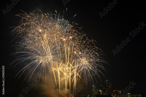 Firework festival with beach foreground and city background at Pattaya beach  Thailand. Colorful firework in celebration festival background