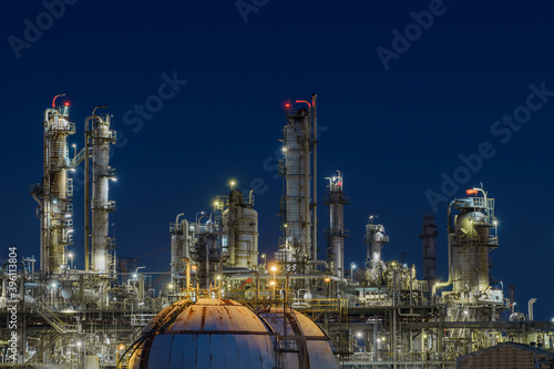 Glitter lighting of petrochemical plant at night, Manufacturing of Oil and gas refinery industrial, Close up of equipment petroleum industry photo