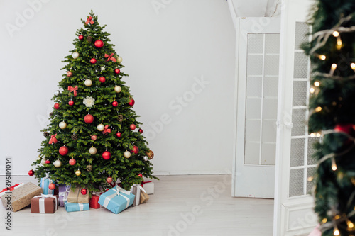 Christmas tree with gift decoration balls garlands new year interior