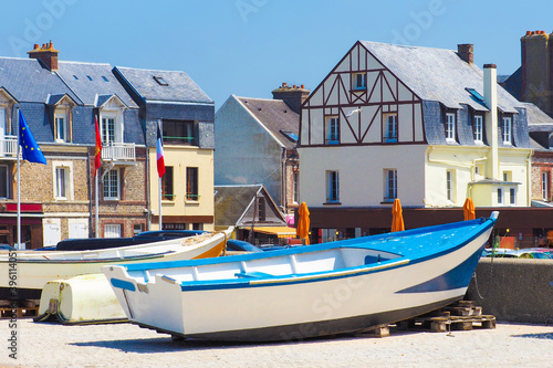 Picturesque landscape beautiful city of Etretat of Normandy, France. Fishing boats near country houses