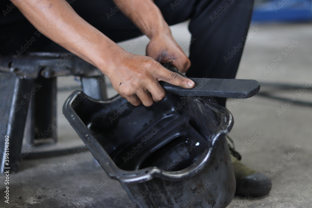 Obraz premium The mechanic is checking the engine.