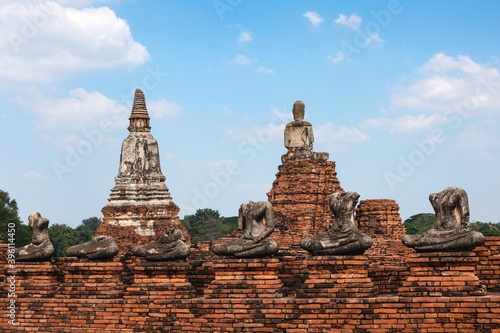 Headless ancient Buddha statues made of stone placed in row, Buddhist temple in ruins. Vintage look. UNESCO World heritage site, Wat Maha That, Ayutthaya, Thailand, Southeast Asia