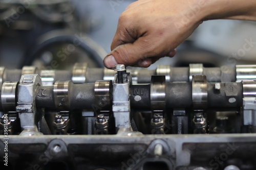 The mechanic is checking the engine.