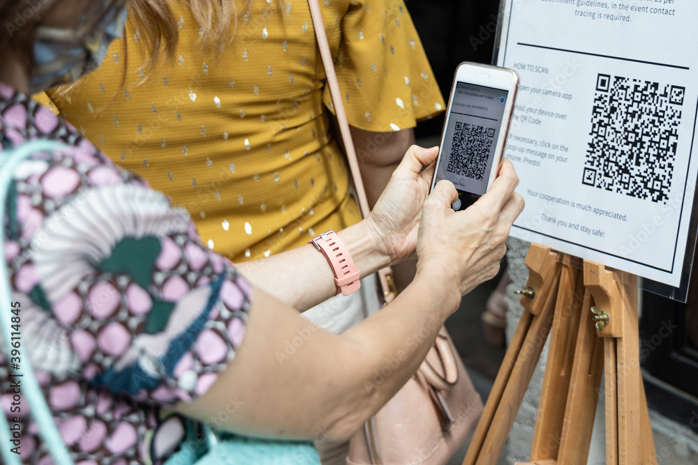 Modified inactive QR Code used. Person scanning QR code with smartphone ...