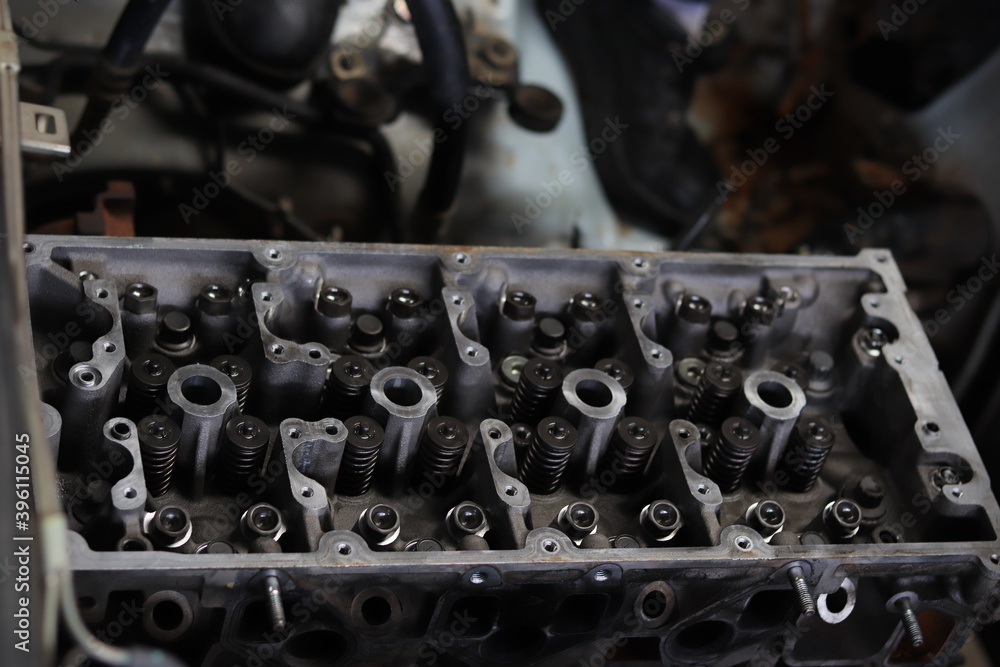The mechanic is checking the engine. The mechanic is checking the engine.