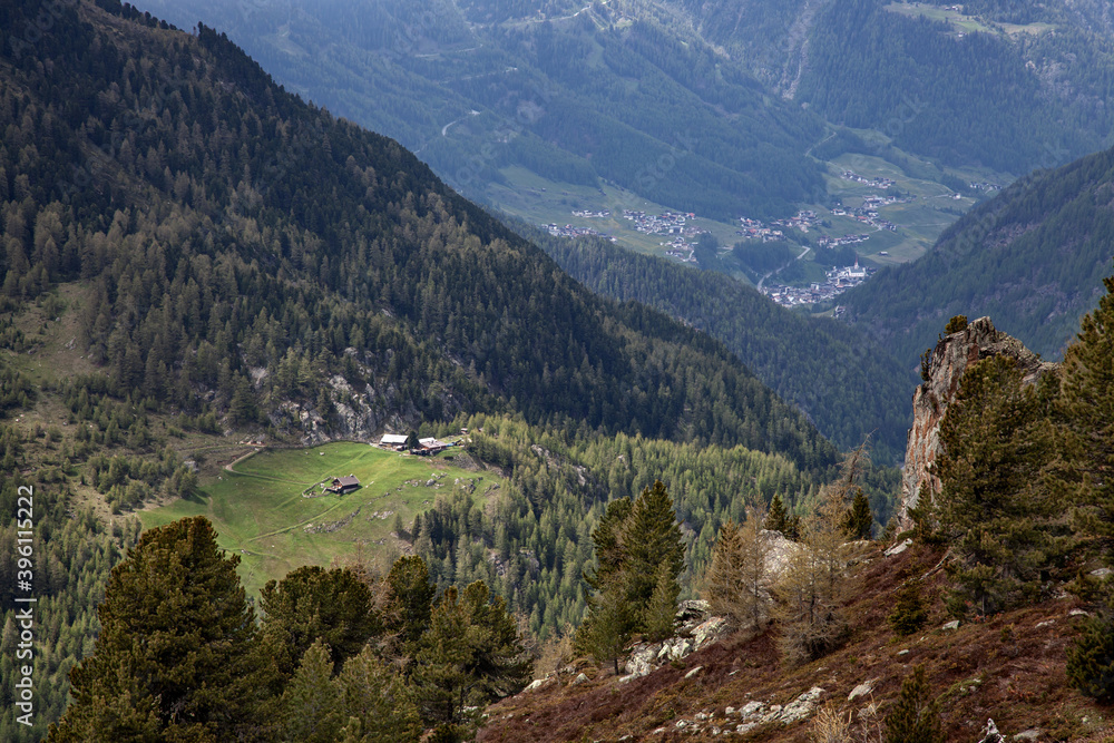 Villages located in the valley of the Alps among forests.