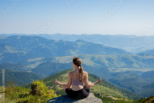 Yoga, Meditation. Woman balanced, practicing meditation and zen energy yoga in mountains. Girl doing fitness exercise sport outdoors in morning. Healthy lifestyle concept.