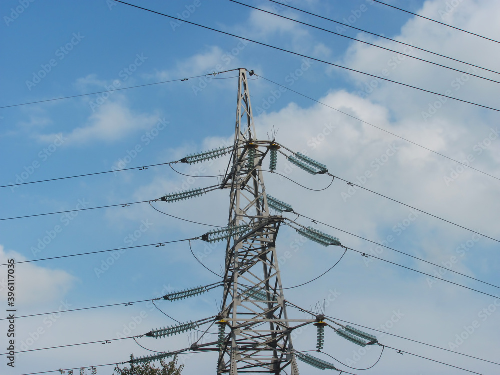 power line support with wires against blue sky with white clouds power line support with wires against blue sky with white clouds