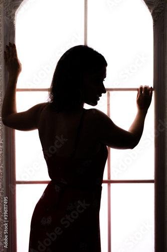 Woman's beautiful sihouette on white window background