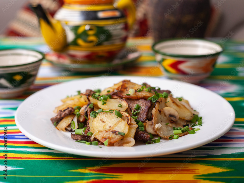 Fried potatoes with pieces of meat. Asian style Fried potatoes with pieces of meat. Asian style
