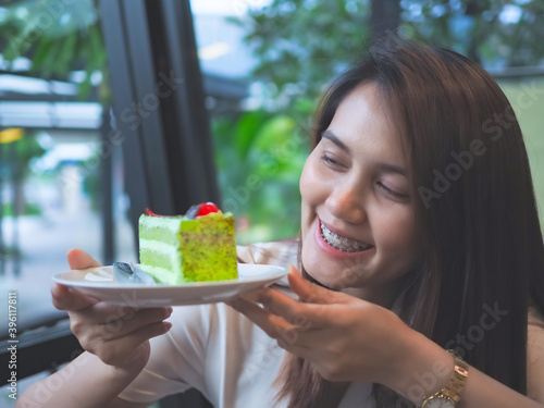 women holding Green tea cake in the cafe in holiday.