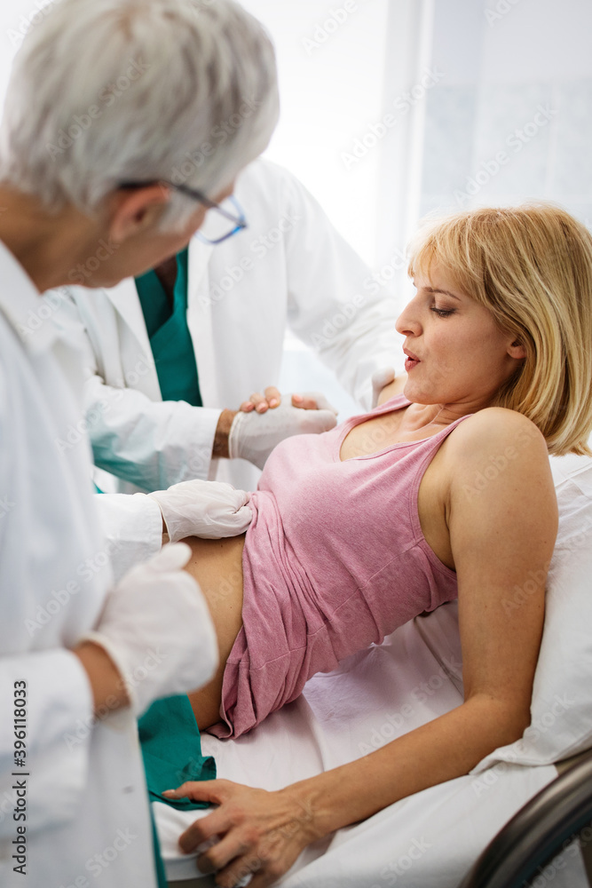 Woman giving birth in hospital with medical team Woman giving birth in hospital with medical team
