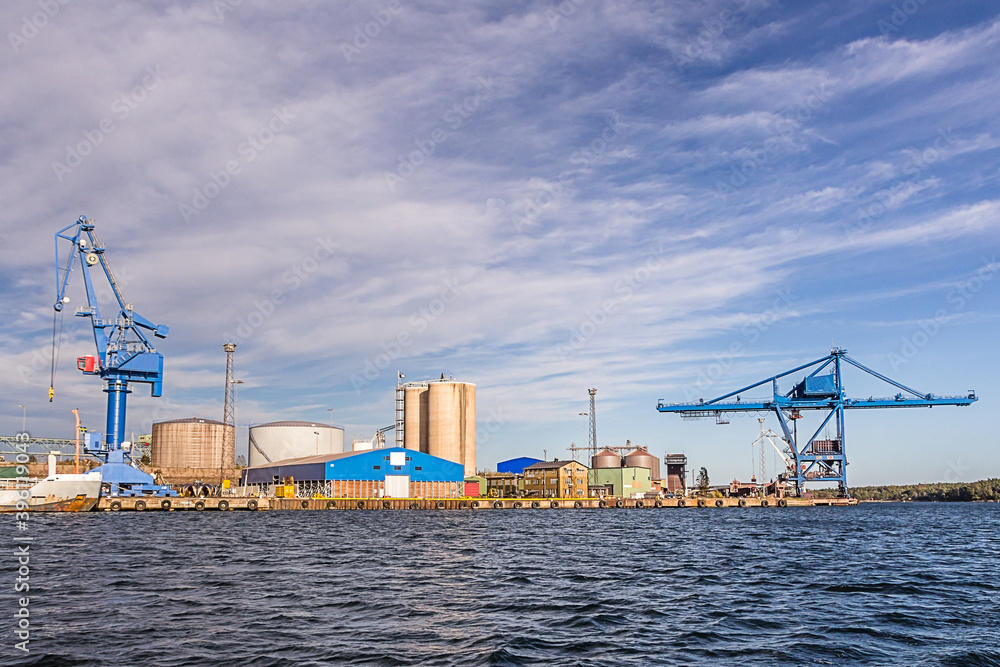 Massive blue crane unload cargo in a seaport in Sweden