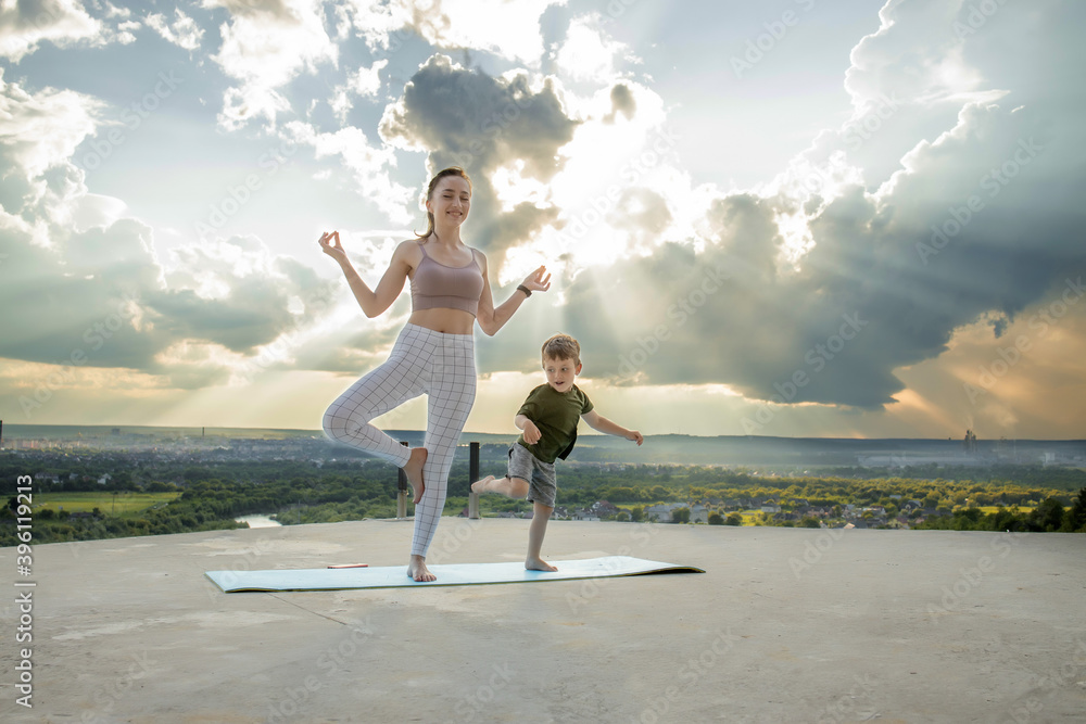 Sportive mother is doing workout with little son. Sports concept Sportive mother is doing workout with little son. Sports concept