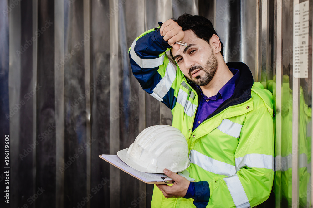 Wall Mural Tired worker, engineer headache hot weather over heat unhealthy working in heavy industry factory