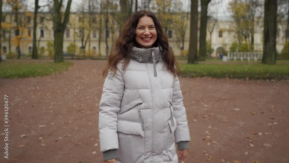 Young pregnant woman walks on footpath in autumn park. Brunette woman with long hair in Catherine Park, Tsarskoye Selo, Saint Petersburg, Russia. Young pregnant woman walks on footpath in autumn park. Brunette woman with long hair in Catherine Park, Tsarskoye Selo, Saint Petersburg, Russia.