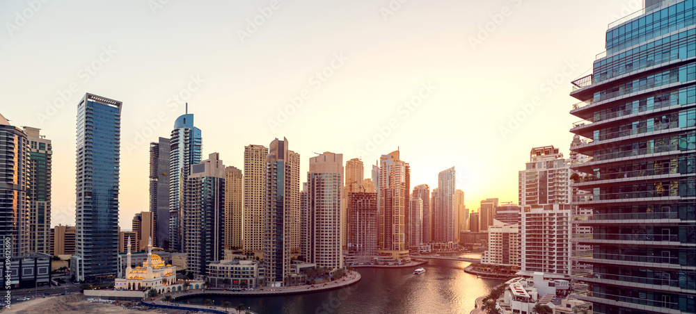 Cityscape and skyscraper at sunset in Dubai Marina.