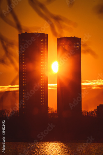 Two highscrapers on sunset with sun among them photo