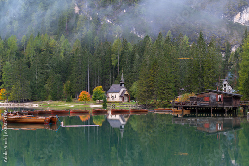 Little chapel at Lake Braies (Pragser Wildsee, Lago di Braies) with boats in foreground. Region of Trentino Alto Adige, Dolomites, Italy