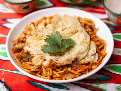  The oriental lagman dish is homemade noodles fried with meat, vegetables and herbs. Eastern cuisine