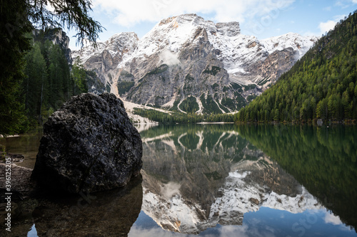 View of Mount Seekofel mirroring in the clear calm water of iconic mountain lake Pragser Wildsee (Lago di Braies) in Italy, Dolomites, Unesco World Heritage, South Tyrol