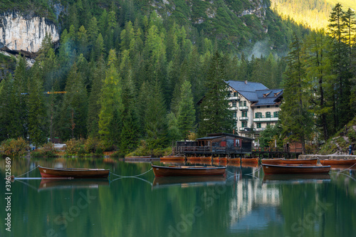 Lake Braies (also known as Pragser Wildsee or Lago di Braies) in Dolomites Mountains, Sudtirol, Italy. Romantic place with typical wooden boats on the alpine lake. Hiking travel and adventure.