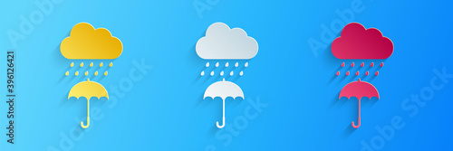 Paper cut Cloud with rain drop on umbrella icon isolated on blue background. Paper art style. Vector.
