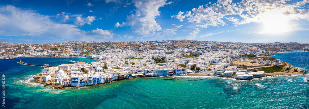 Wide aerial panorama of the town of Mykonos island, Greece, with the little venice district, the famous windmills and the old port