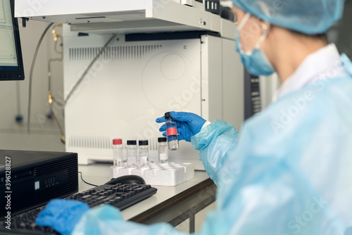 Female scientist looking at the scientific sample in the CDC laboratory. 