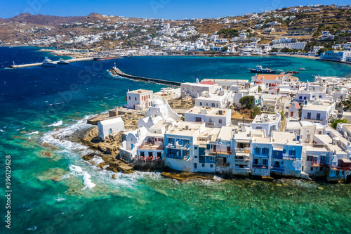 Aerial view to the whitewashed houses and churches of the old town of Mykonos. Cyclades islands, Greece, on a windy day with waves