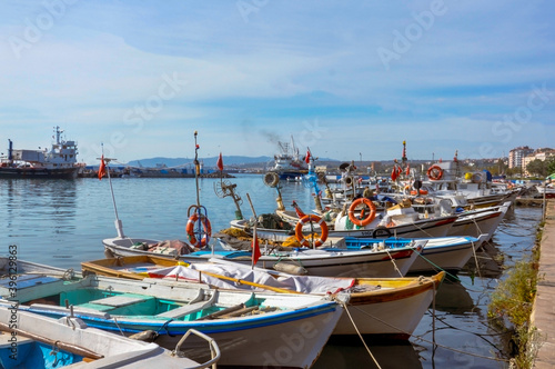 Several fishing boats in the harbor. View from the seaside. "Selector focused on the foreground."