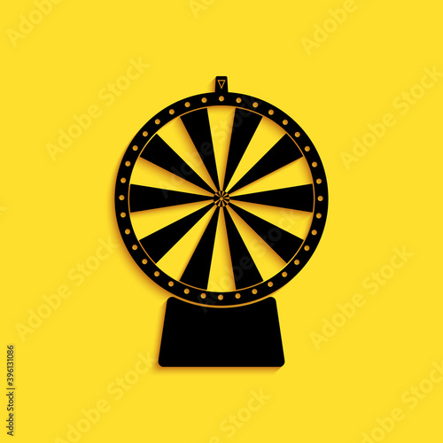 Black Lucky wheel icon isolated on yellow background. Long shadow style. Vector.