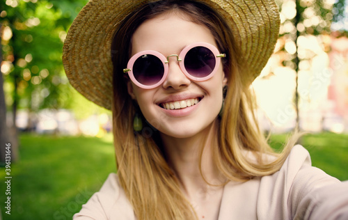 Pretty woman in hat and sunglasses outdoors walk park fresh air nature