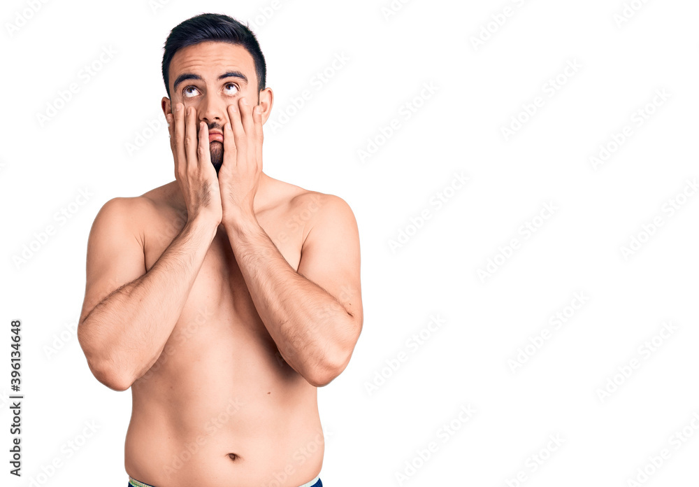 Young handsome man wearing swimwear tired hands covering face, depression and sadness, upset and irritated for problem Young handsome man wearing swimwear tired hands covering face, depression and sadness, upset and irritated for problem