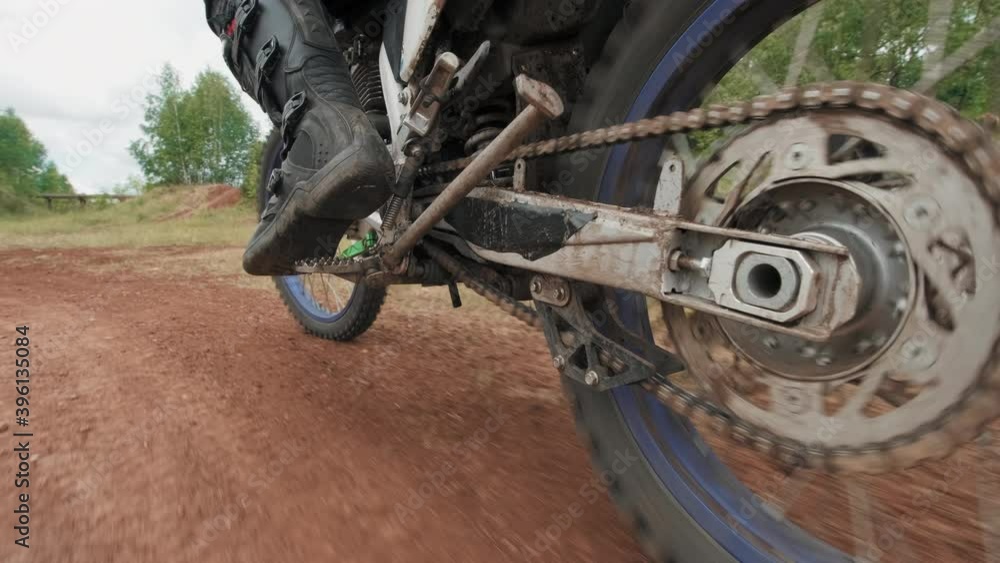 Tracking close up of man in helmet riding motorcycle and training on off-road track Tracking close up of man in helmet riding motorcycle and training on off-road track