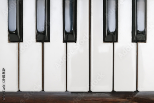 Classical piano keyboard, black and white keys of musical instrument close up, top view