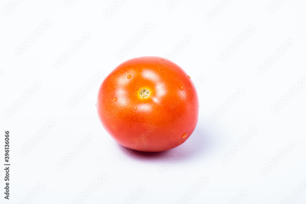 Single delicious red tomato without stalk. Isolated on white background Single delicious red tomato without stalk. Isolated on white background