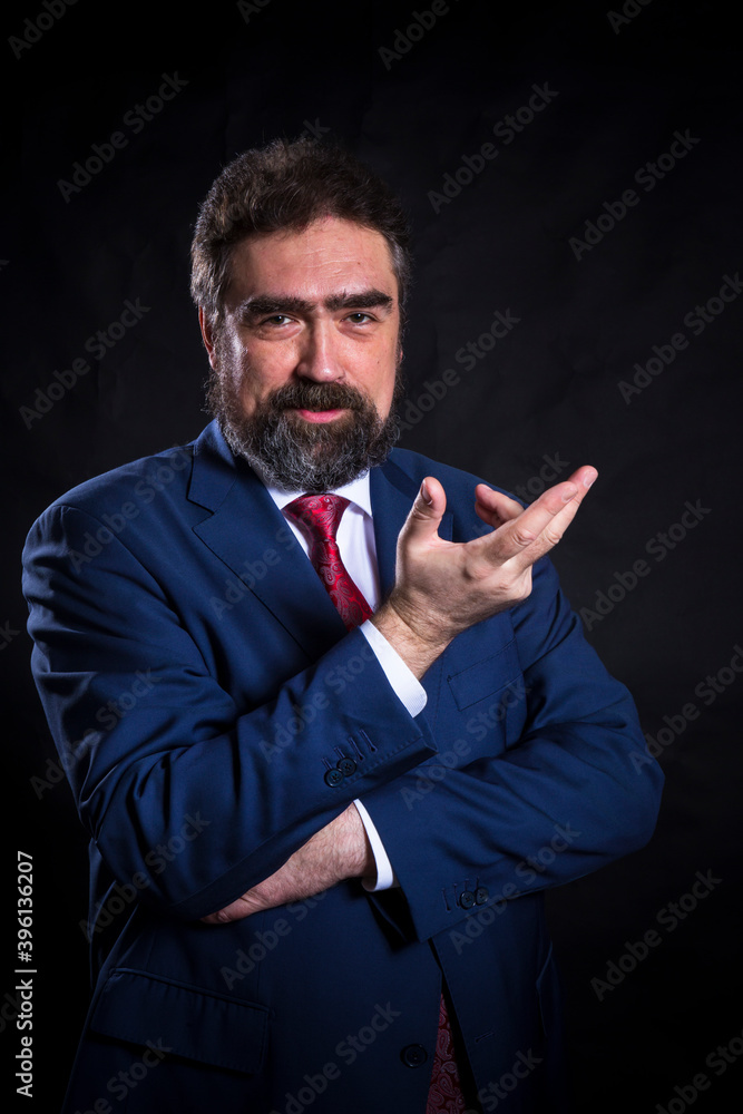 Mature businessman dressed in blue suit with red tie studio portrait. Mature businessman dressed in blue suit with red tie studio portrait.