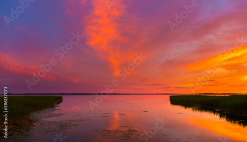 Beautiful colorful sunset over the lake summer landscape. © idea_studio