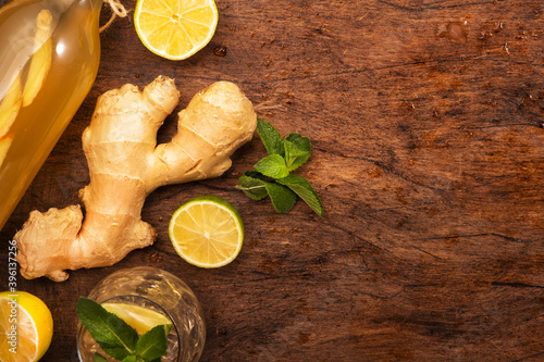 Ginger Ale Cocktail with Beer, Lime, Lemon and Mint in glaass on wooden table, top view