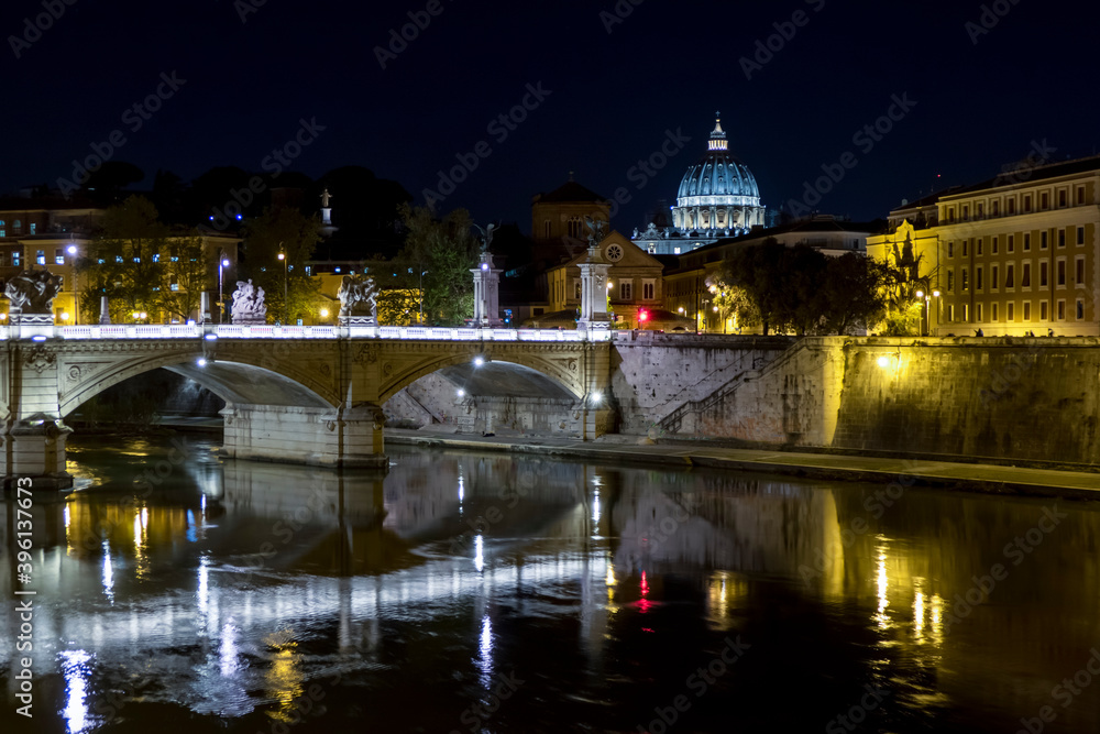 historic bridge over the Tiber in Rome with St. Peter's in the background