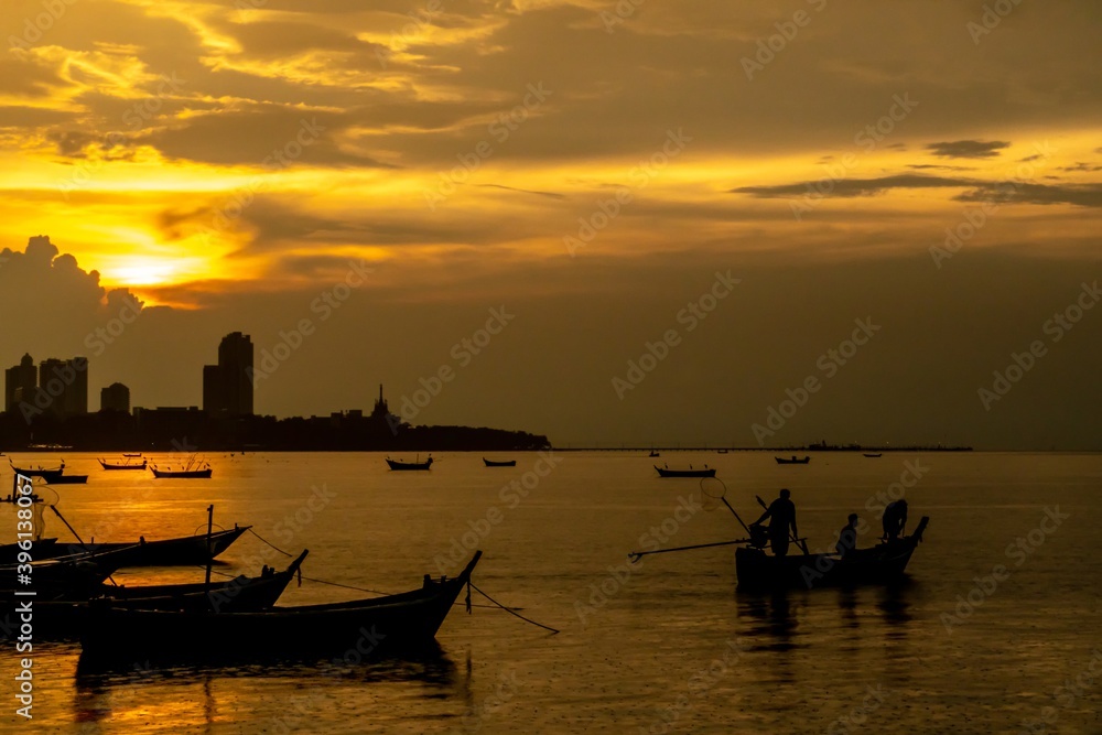 local fisherman and small fishing boats at sunset.