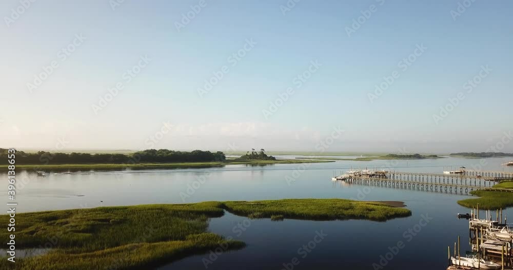 Peaceful Sunrise drone takeoff launch over piers, waterway, and marsh at Trails End Park in Wilmington North Carolina Peaceful Sunrise drone takeoff launch over piers, waterway, and marsh at Trails End Park in Wilmington North Carolina