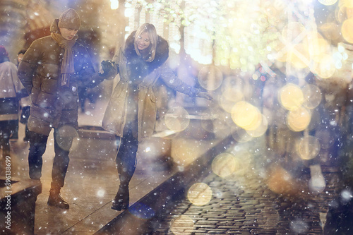 couple in love on a christmas walk in the city, evening snowfall december holiday new year © kichigin19